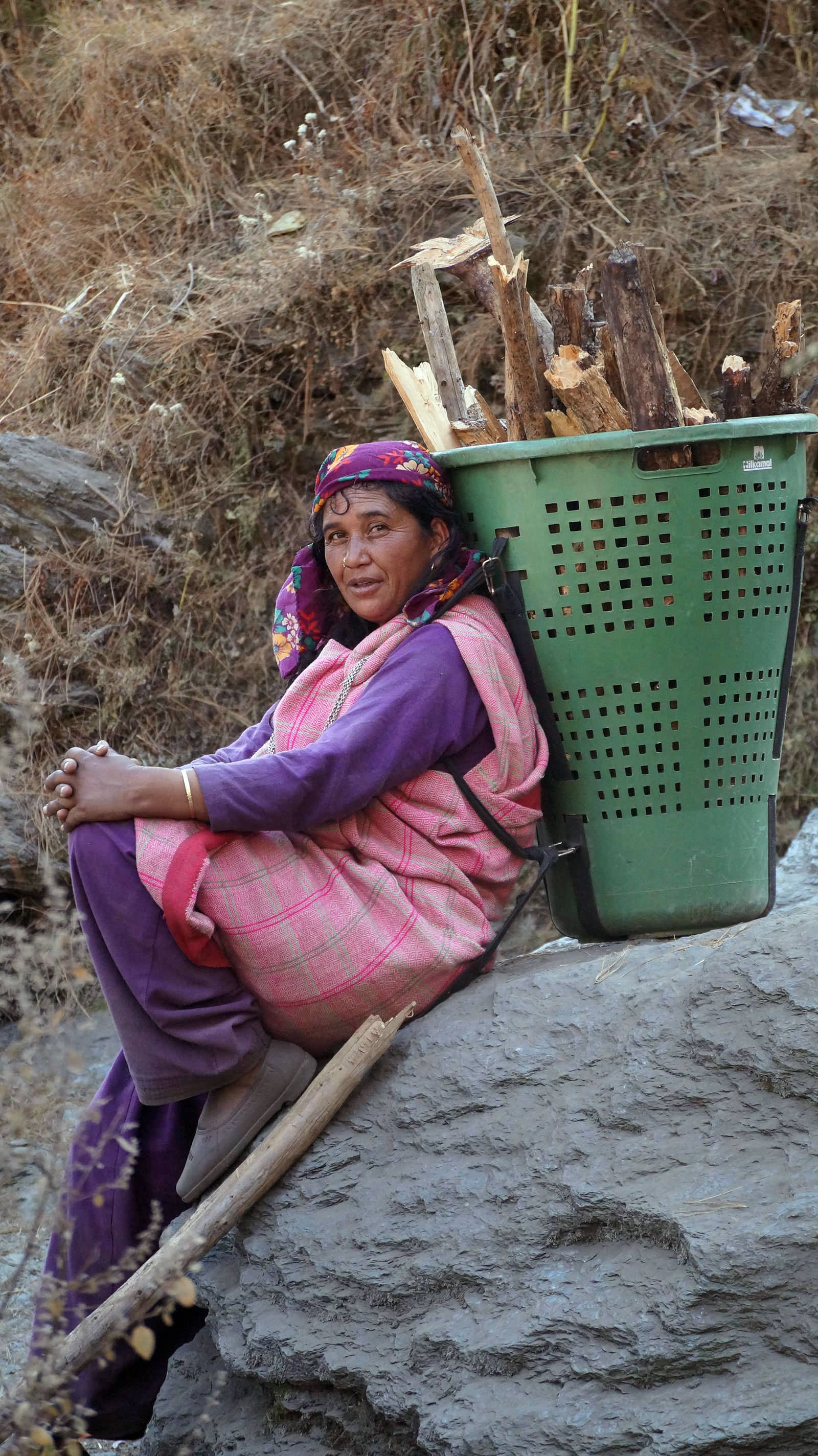 A young woman carrying firewood